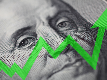 A close-up of a $100 bill, focused on Ben Franklin's portrait with a zigzagging green arrow superimposed over the image.