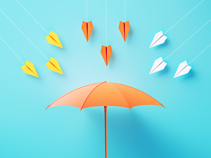Insurance concept of an orange umbrella on a blue background with paper airplanes flying at the umbrella.